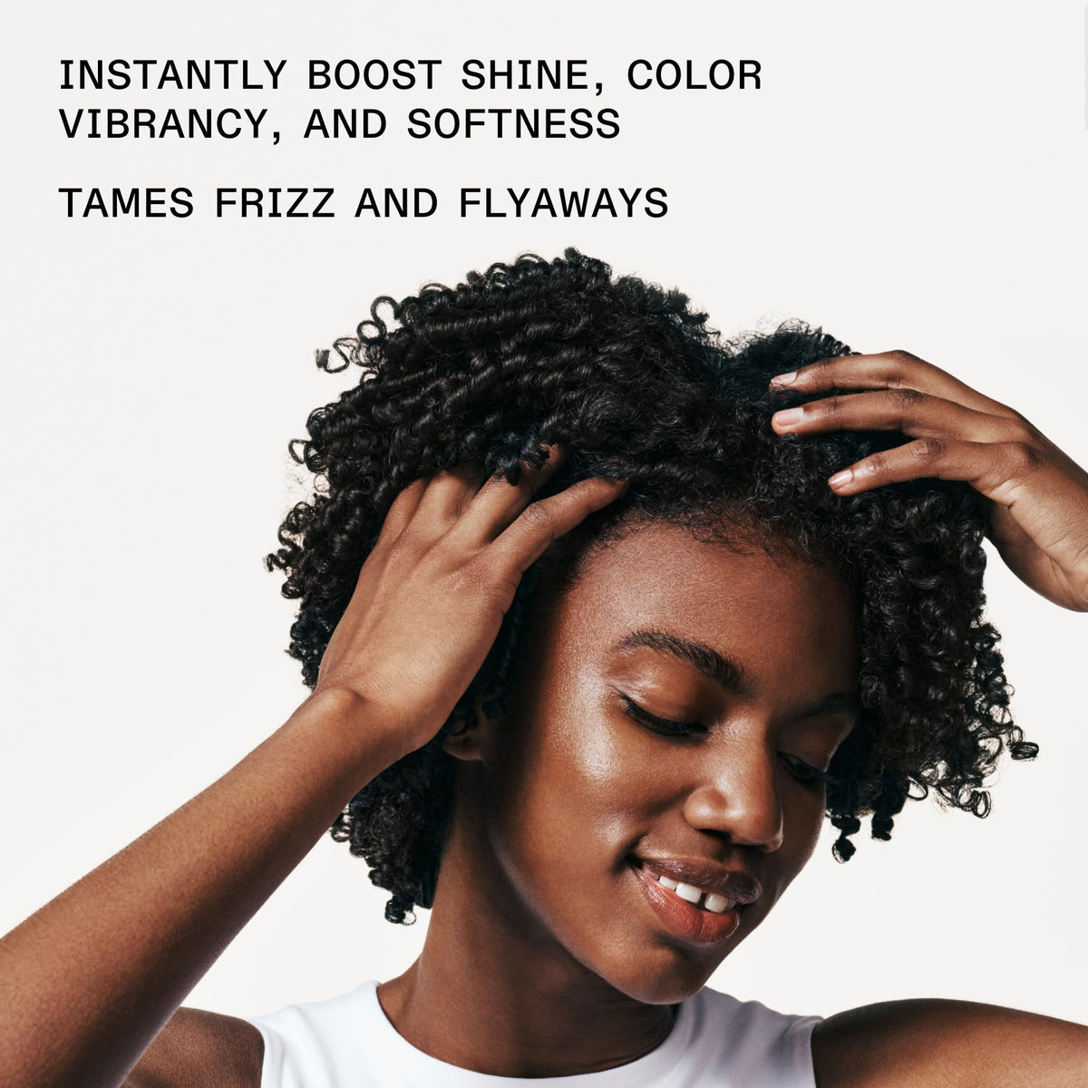 Applying Olaplex No.7 to damp hair mid-lengths demonstrating heat-protection preparation