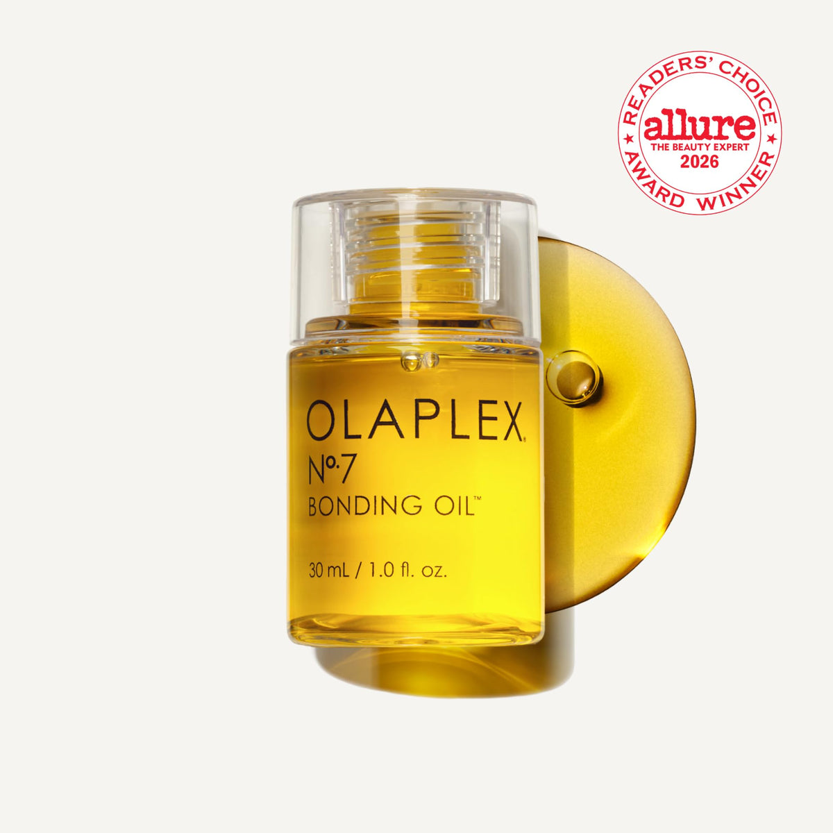 Close-up oil droplet from Olaplex No.7 showing concentrated texture and glossy finish