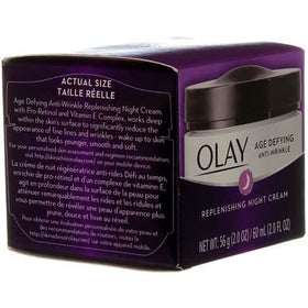 Olay 2 oz jar next to coin displaying compact travel-friendly benefit