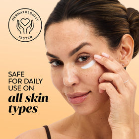 Olay cream being applied with fingertips, illustrating gentle under-eye use