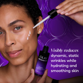 Olay serum dispensed from pump onto fingertip, showing easy application