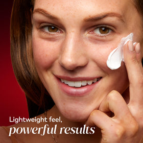Woman applying Olay cream to face showing hydration and smooth finish