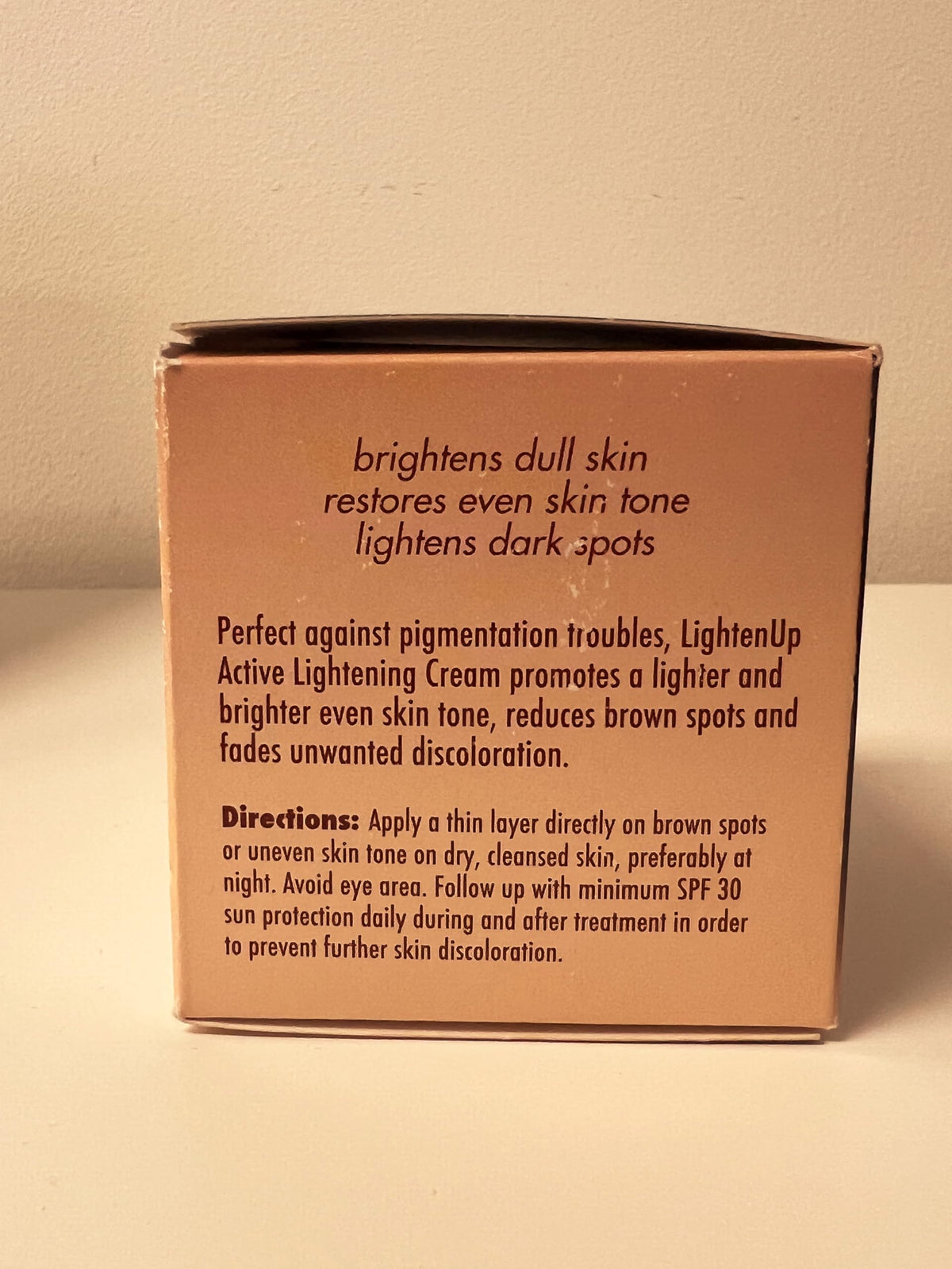 OMIC Lighten-Up on bathroom counter during skincare routine, suggests daily use benefit