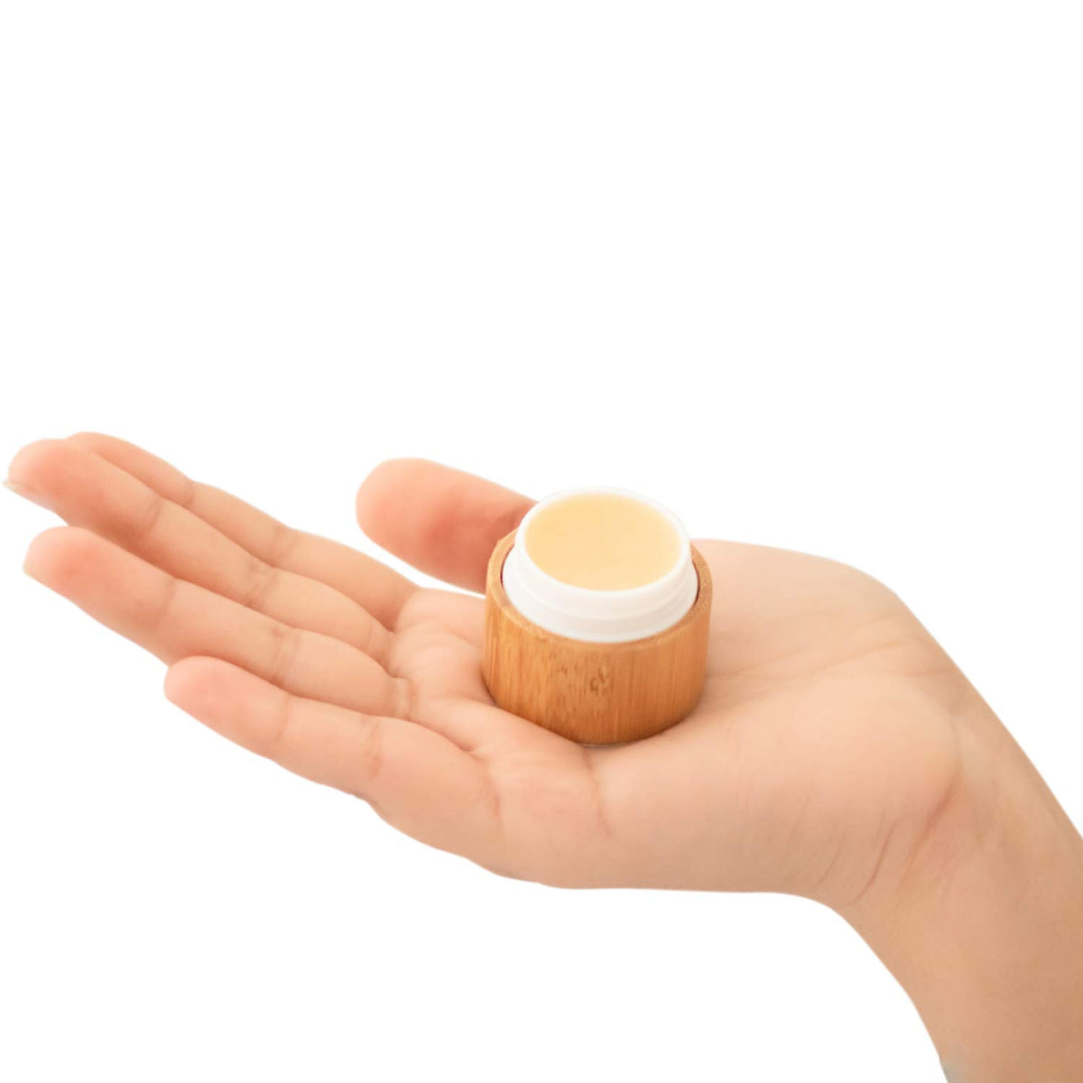 OMORFEE size comparison beside a coin showing compact travel-friendly design