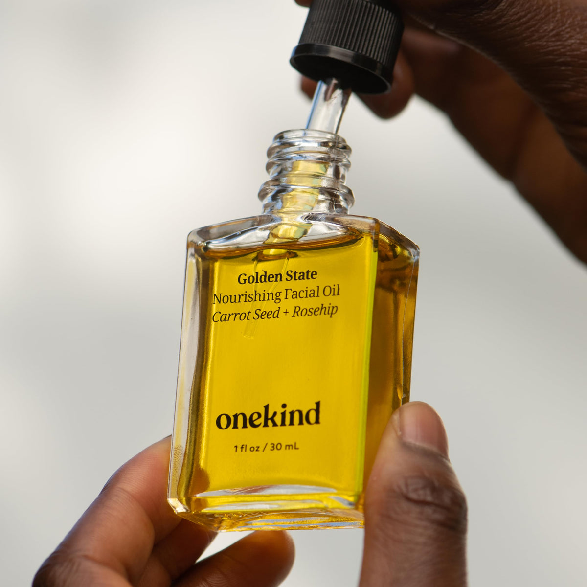 Onekind in bathroom routine setting showing easy layering under skincare and SPF