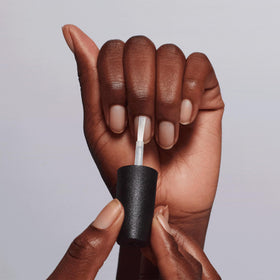 OPI bottle next to ruler for scale showing compact primer size