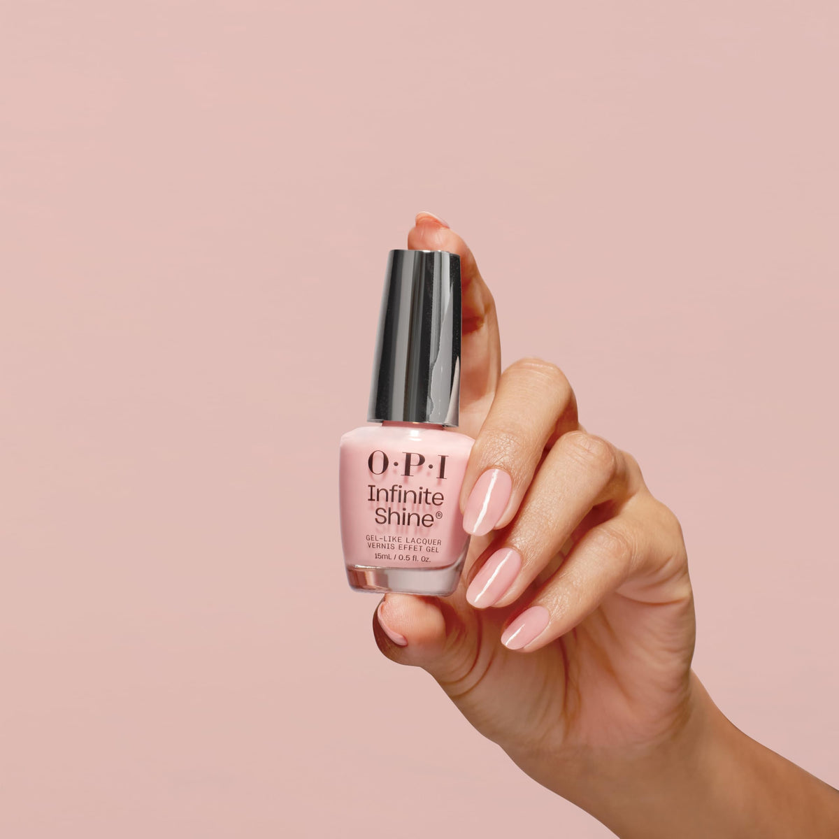 Hand holding OPI Passion bottle for scale and easy at-home use benefit