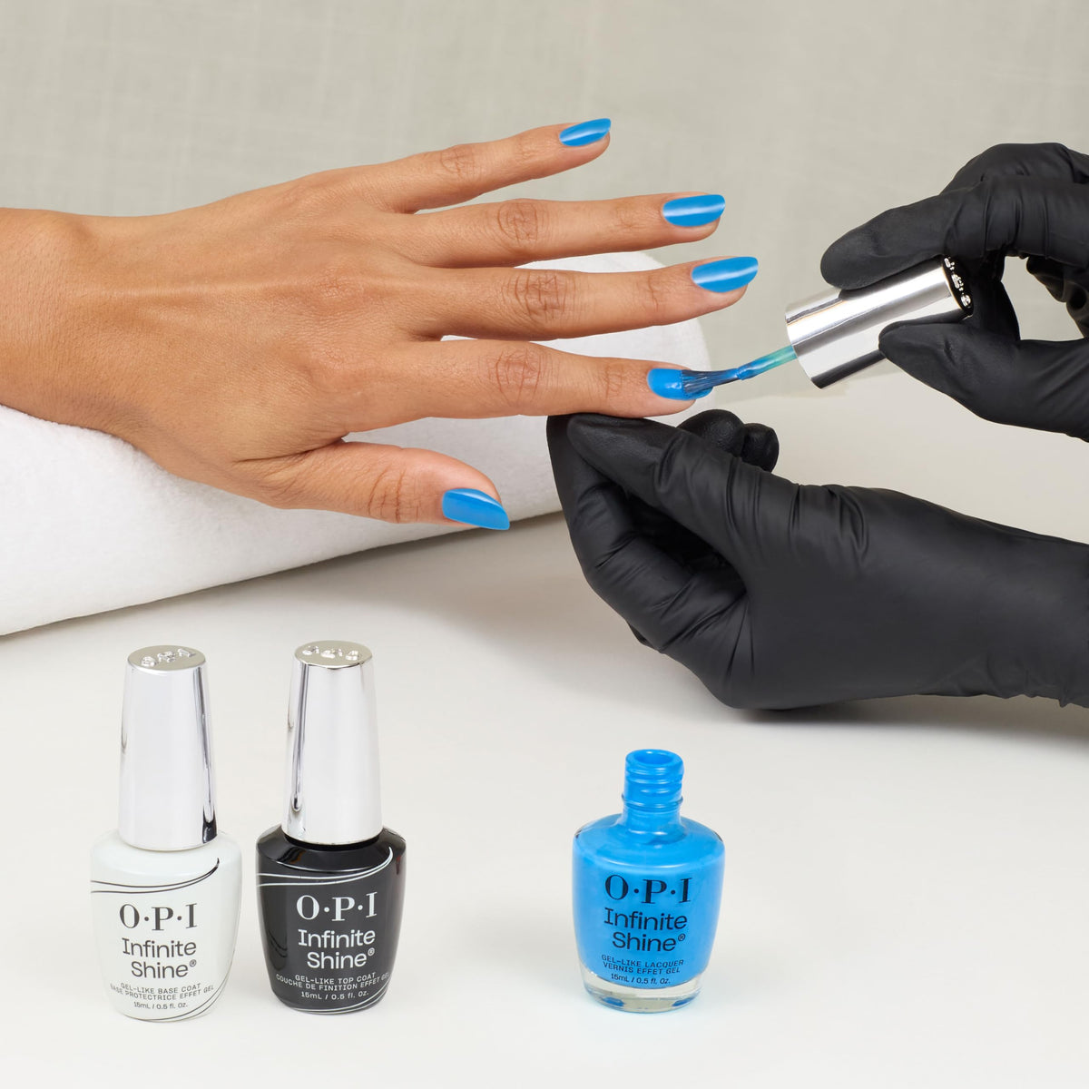 OPI bottle staged on sand by the sea evoking summer-ready color