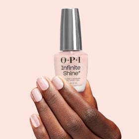 OPI bottle next to coin for scale showing compact, travel-friendly size