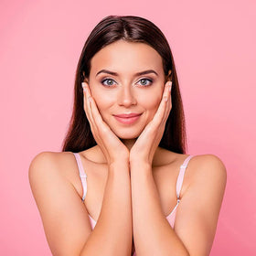 OPO misting rose hydrosol into hand to hydrate skin and provide instant refreshment