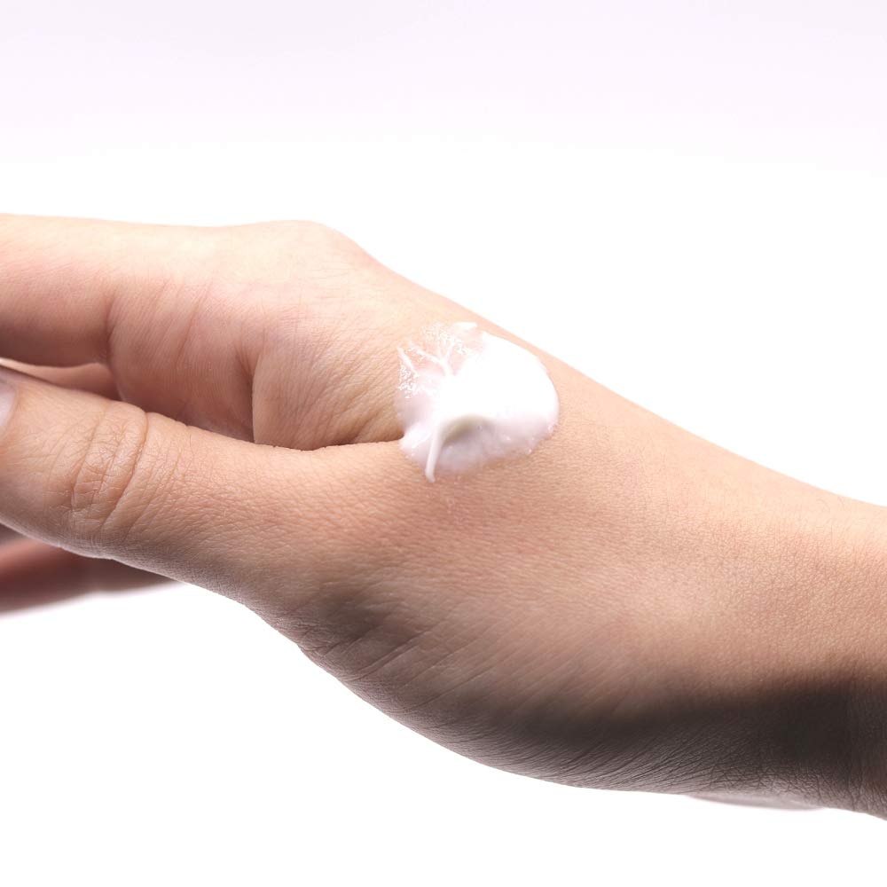 Organys Spark beside a finger to show 0.5 oz size and portability