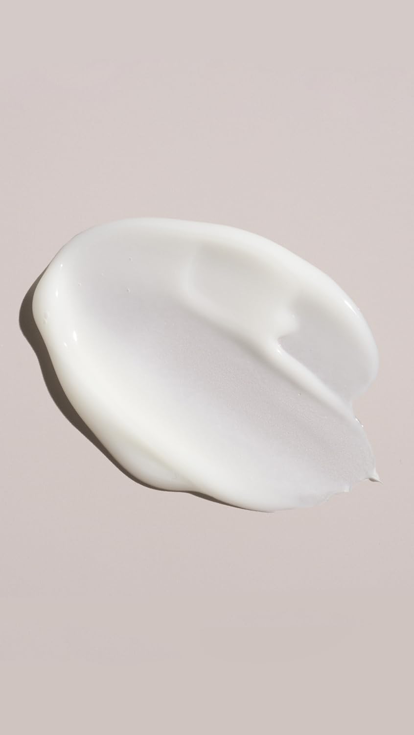 Oribe conditioner being applied in shower for easier detangling