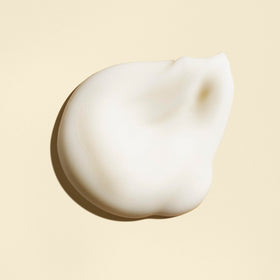 Oribe Balm D'Or next to ruler to show 3.4 oz scale and travel-friendly size