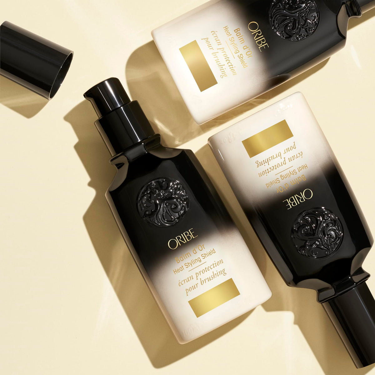 Oribe Balm D'Or open cap texture showing lightweight cream and spreadability