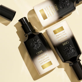 Oribe Balm D'Or open cap texture showing lightweight cream and spreadability