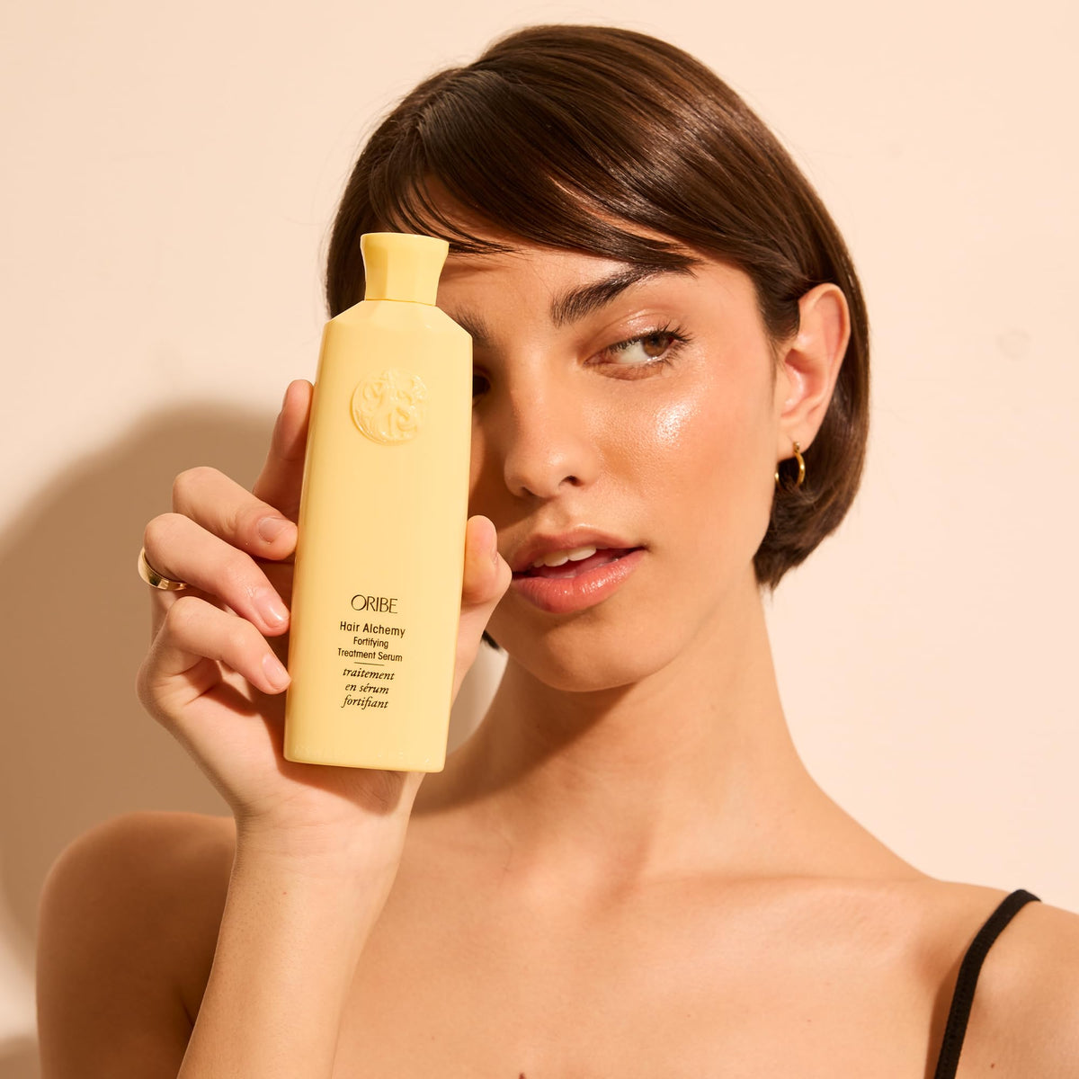 Oribe on bathroom shelf in lifestyle scene for salon-quality benefit