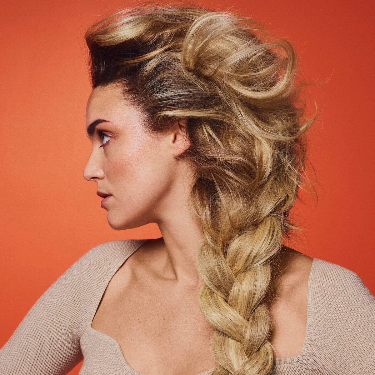 Oribe Bright Blonde bottle on vanity with scent notes suggesting luxurious experience benefit