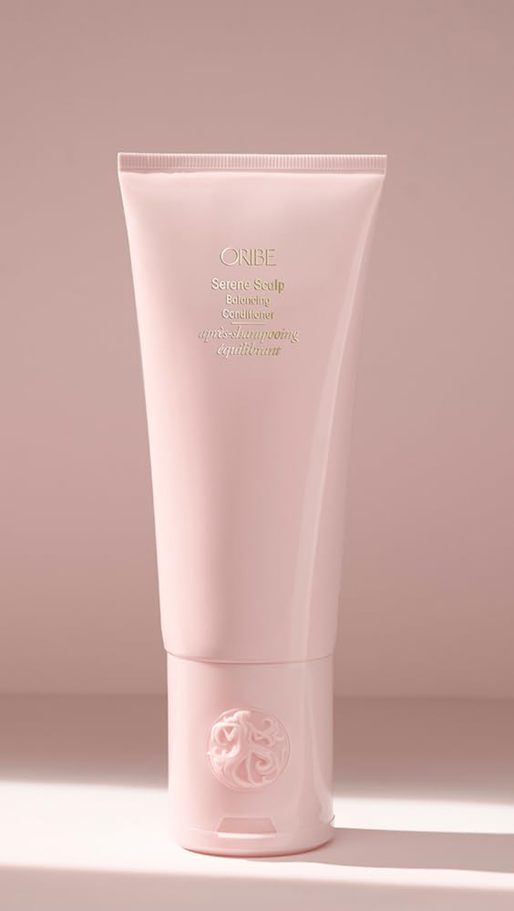 Oribe conditioner styled on bathroom shelf indicating premium self-care routine