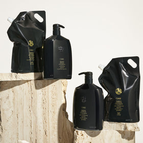 Creamy Oribe conditioner texture in hand showing rich moisturizing consistency