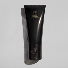 Oribe conditioner being dispensed to hand demonstrating smooth slip for styling ease