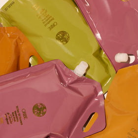 ORIBE scent notes visual showing bergamot, jasmine, and sandalwood