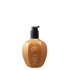 Oribe bottle front view showing branding and pump, conveys luxury hand care