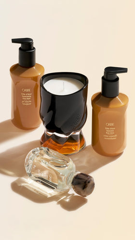 ORIBE on bathroom shelf styled with towels suggesting a luxurious routine benefit