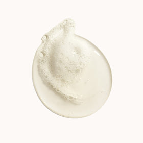 ORIBE pouch pouring into bottle illustrating easy refill and less waste
