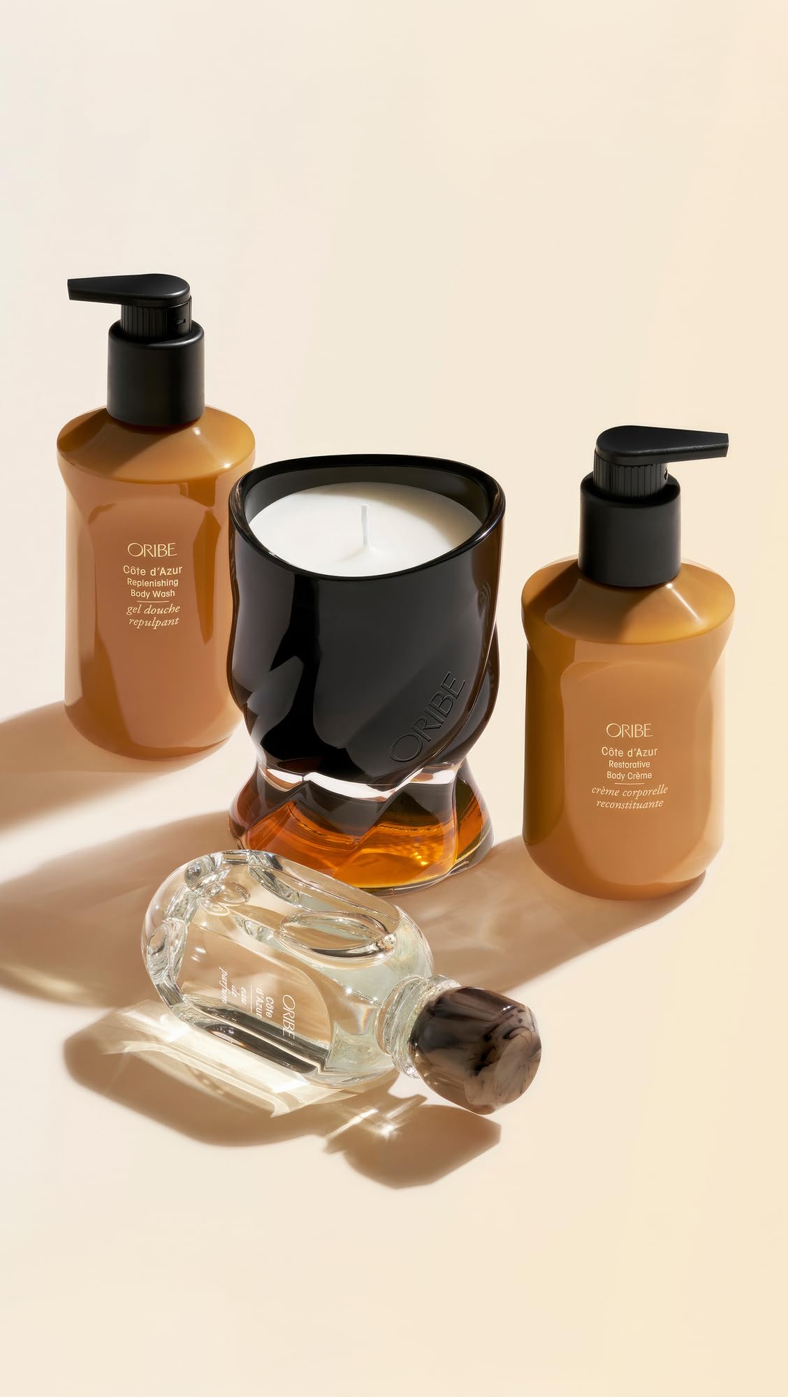 ORIBE bottle next to common objects for scale, showing travel-friendly size