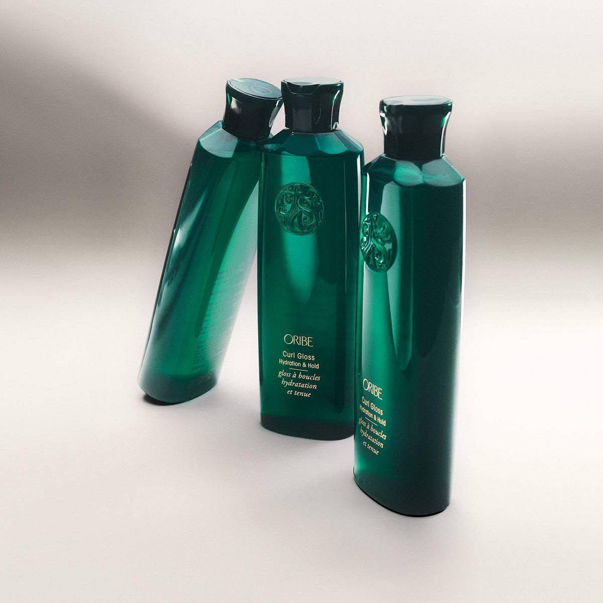 ORIBE product being diffused on curly hair showing enhanced definition