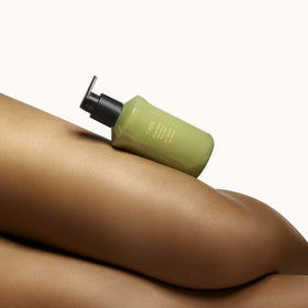 ORIBE creamy lather on hand demonstrating gentle, softening cleanse