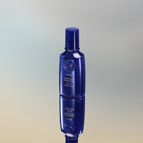 Lifestyle bathroom shelf with Oribe Featherbalm conveying luxury routine and polished results