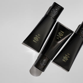 Oribe label close-up highlighting key ingredients aloe vera and cherry bark benefit