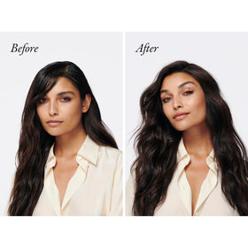 Oribe Gold Lust held in hand to show compact travel-friendly size and convenience