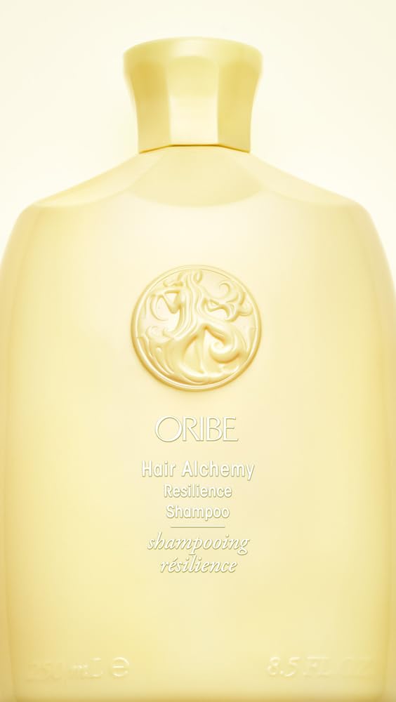Oribe Hair Alchemy bottle in hand to show 8.5 fl. oz. scale and ease