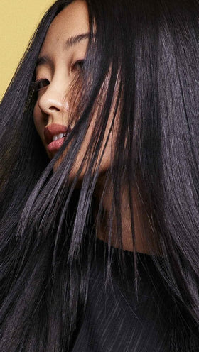 Oribe Hair Alchemy shampoo applied in shower showing gentle cleansing benefit