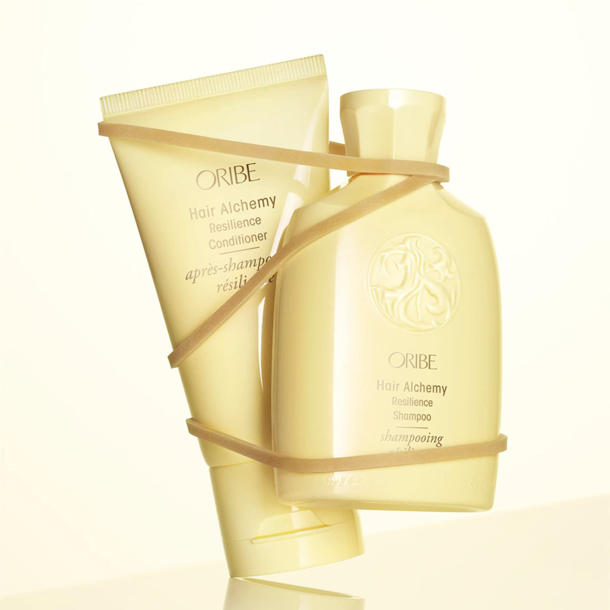 Oribe conditioner texture close-up showing creamy pour and hydration benefit