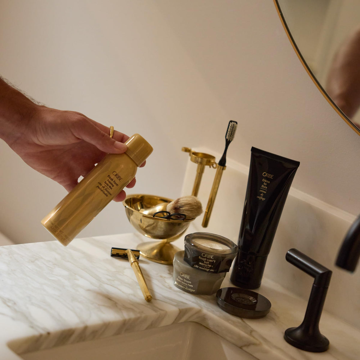 Oribe on bathroom vanity with accessories showing everyday luxury and convenience benefit