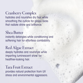 Person applying Oribe Run-Through in shower showing easier detangling and slip