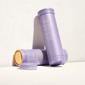 ORIBE product held in hand for size comparison, convenient travel-friendly benefit