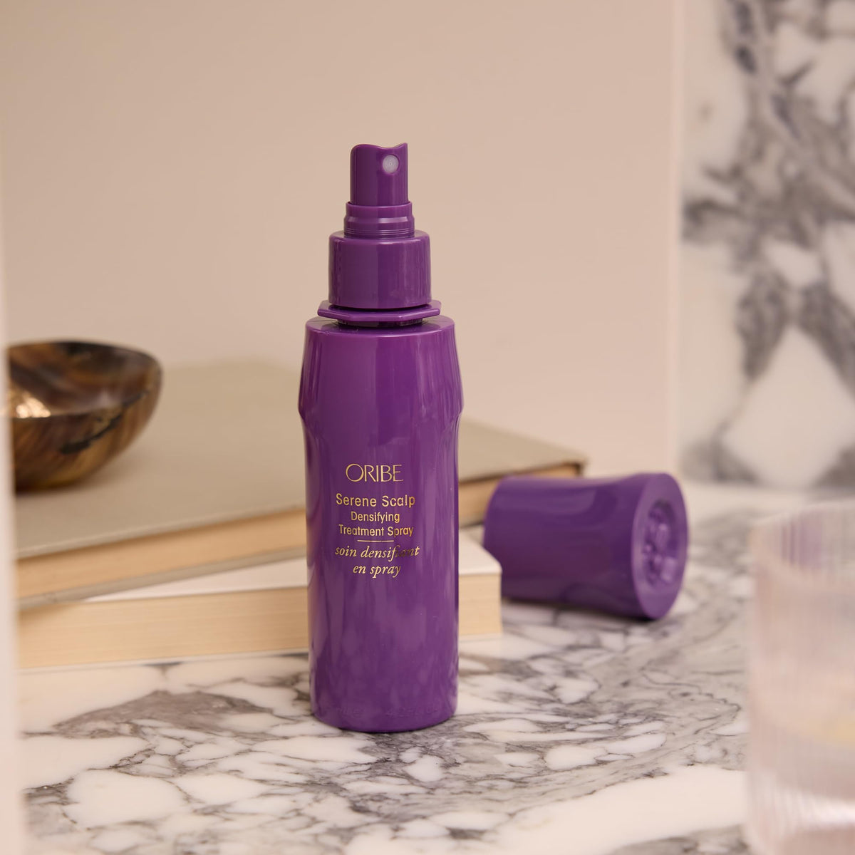 Oribe bottle on bathroom counter indicating inclusion in daily care routine