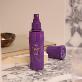 Oribe bottle on bathroom counter indicating inclusion in daily care routine