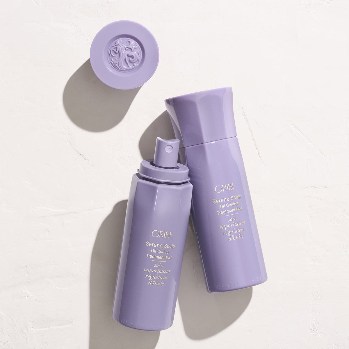 ORIBE Serene Scalp mist applied to dry roots in salon scene, illustrates oil-control benefit