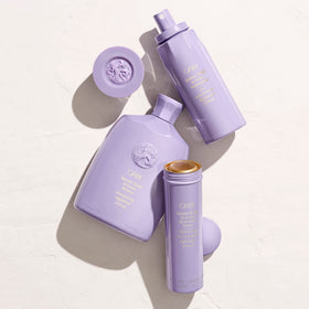 ORIBE Serene Scalp mist held in hand for scale, demonstrates travel-friendly 4.2 oz benefit