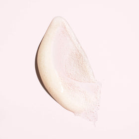 Oribe serene scalp scrub applied to wet hair in shower demonstrating deep-clean benefit