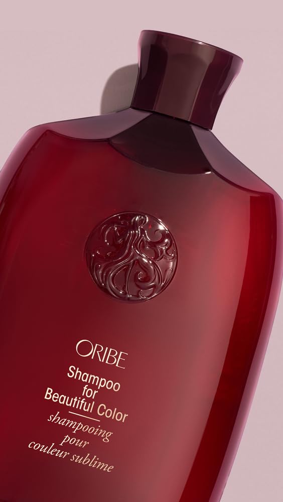 ORIBE shampoo placed on bathroom counter with styling tools implying color protection and salon-quality results