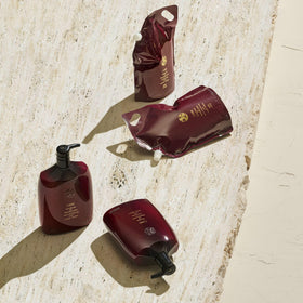 Oribe refill beside a standard bottle for scale and value clarity
