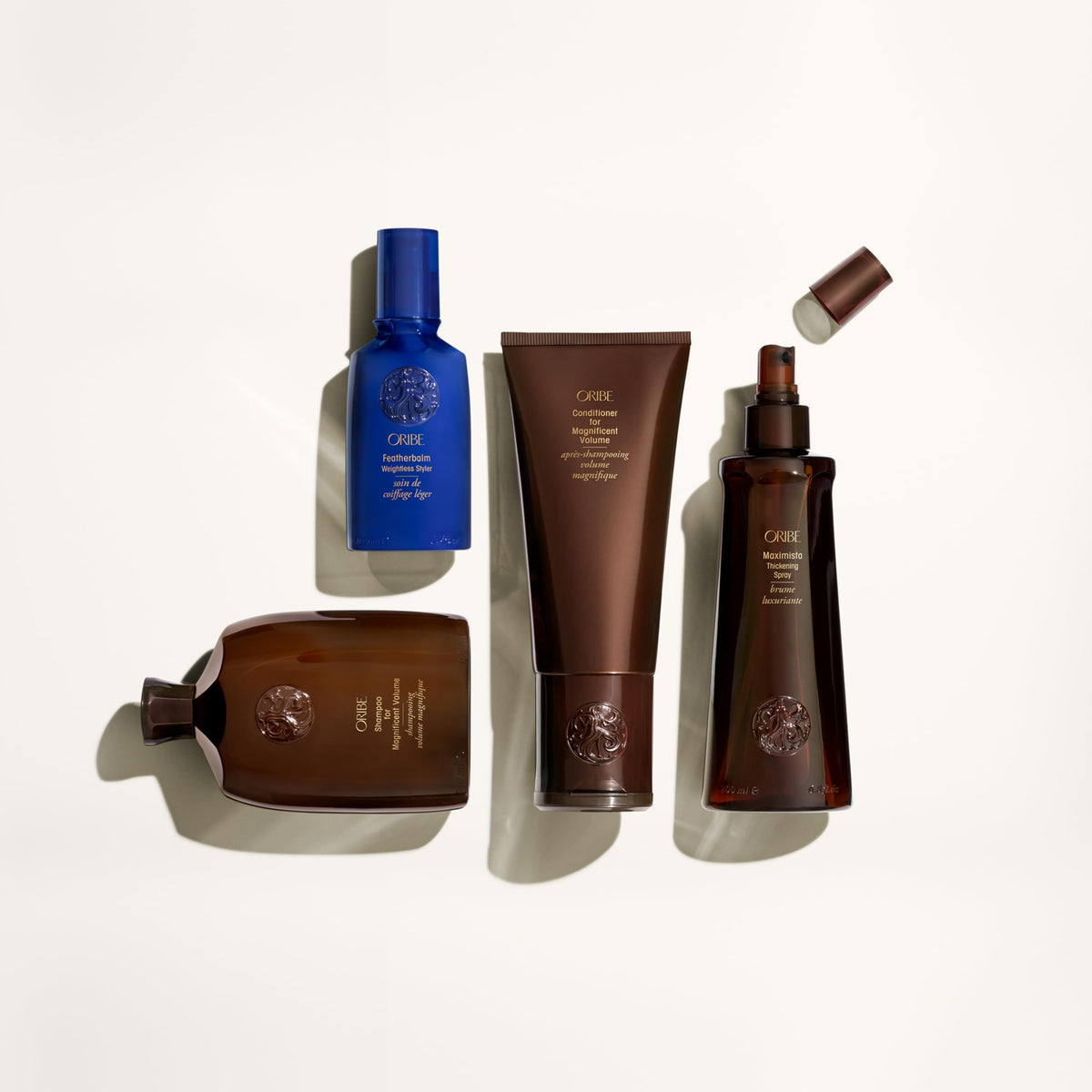 Oribe shampoo placed on bathroom shelf in use-ready setting promoting daily volume