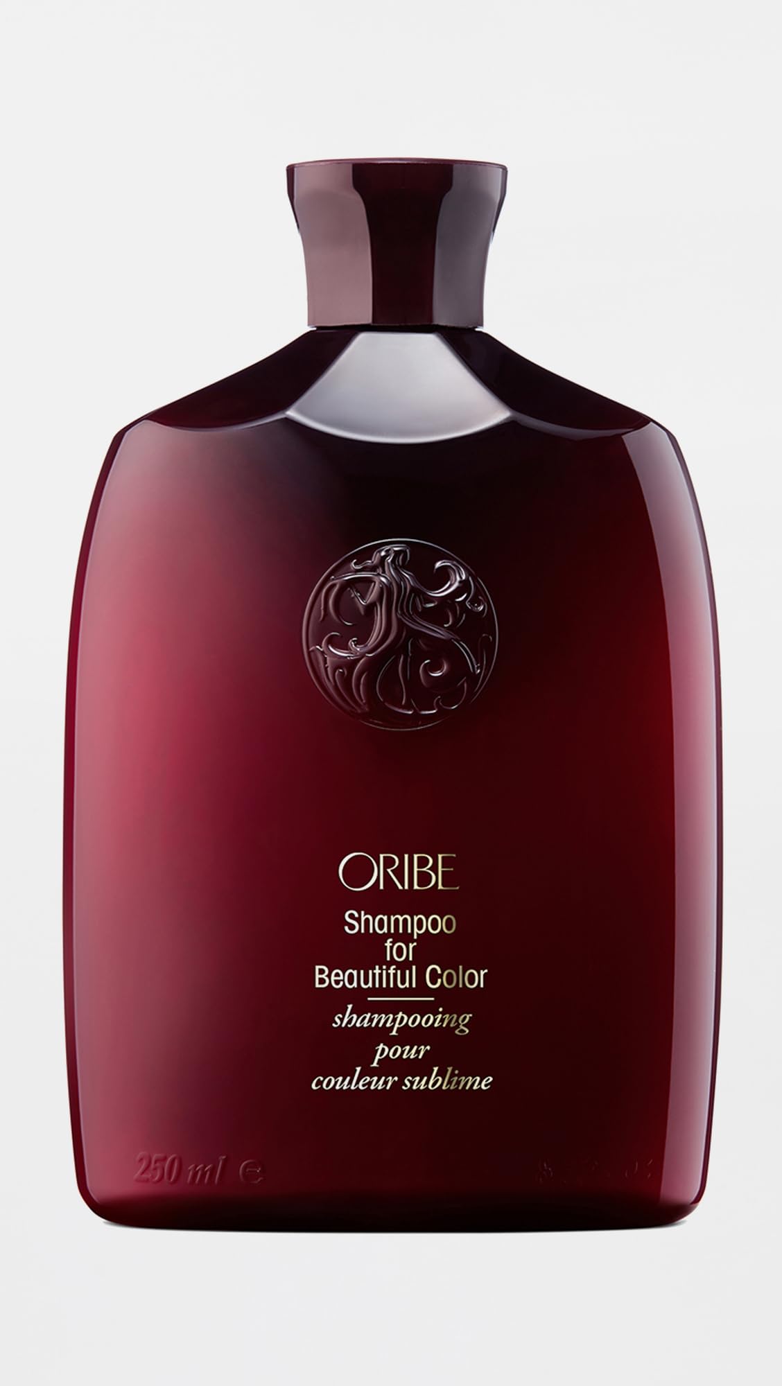 ORIBE creamy shampoo lather close-up showing texture and gentle foam that preserves color while cleansing