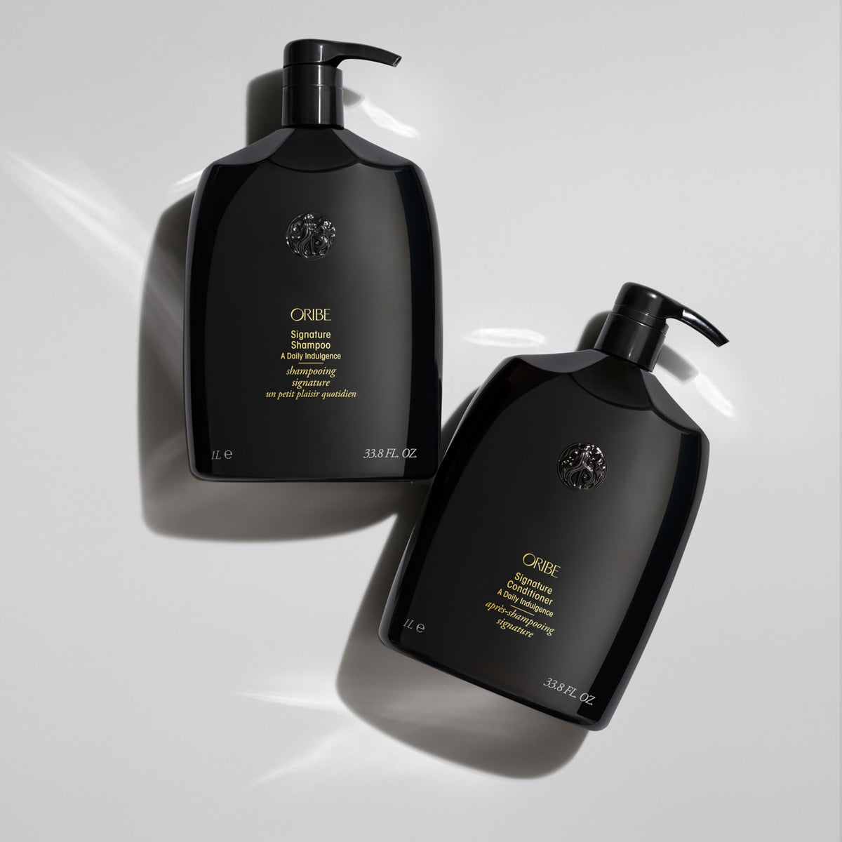Oribe signature conditioner applied in shower demonstrating smooth detangling benefit